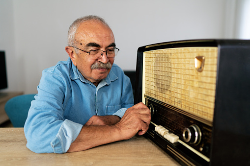 Senior man listening radio