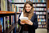 Woman reading a book in the library