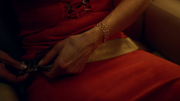 Woman fasten seat belt in first class cabin. Hands locking safety tool closeup. Unrecognized luxury passenger businesswoman flying private jet. Wealthy lady preparing for flight on corporate trip.