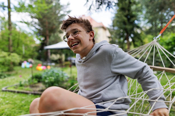 Teenage boy relaxing and playing on hammock on a spring dayCanon R5