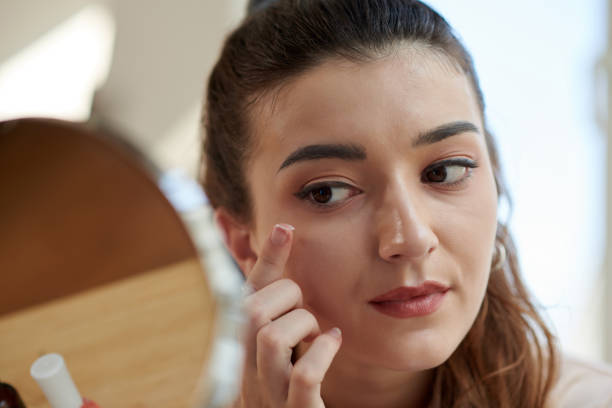istock Woman Applying Eye Cream 1456171518