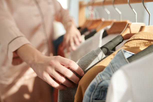 istock Woman Checking Clothes on Racks 1456171523