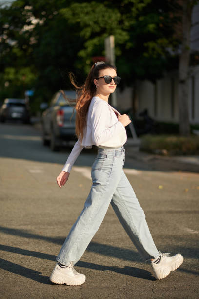 istock Young Woman Crossing Road 1456171530