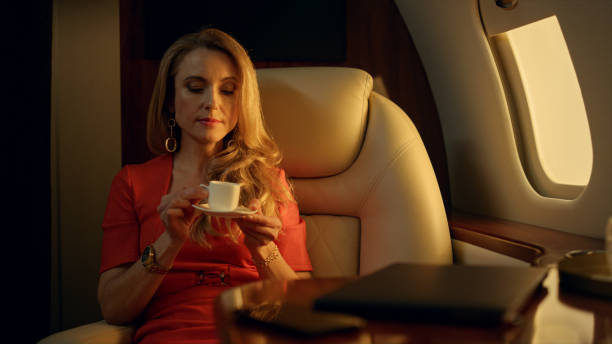 istock Tired entrepreneur resting airplane closeup. Beautiful blonde drinking coffee 1456174055
