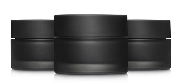 istock Black cosmetic cream jars on white 1456176828