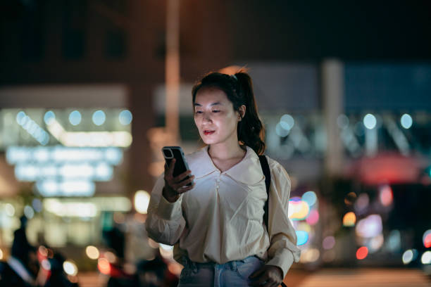 istock Young businesswoman using smartphone in financial district 1456177525