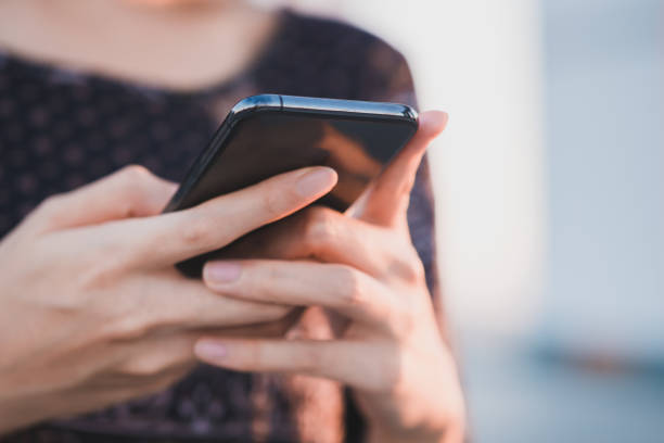 istock Young woman using a mobile phone by texting the message to communicate with someone, copy space 1456182206