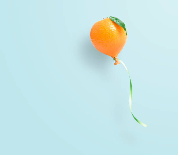 istock Fresh orange balloon concept on light blue 1456183715