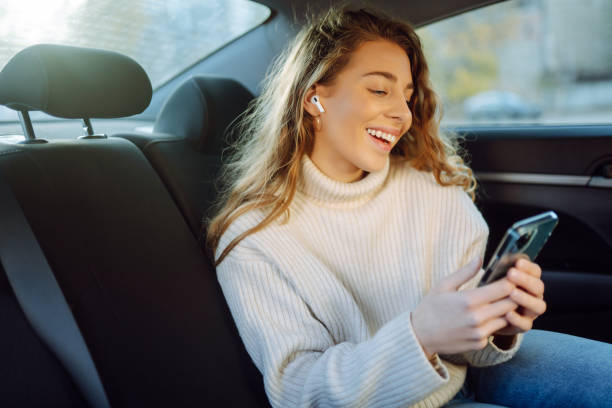 istock Young Woman using her phone during Traveling in a Car. 1456187493
