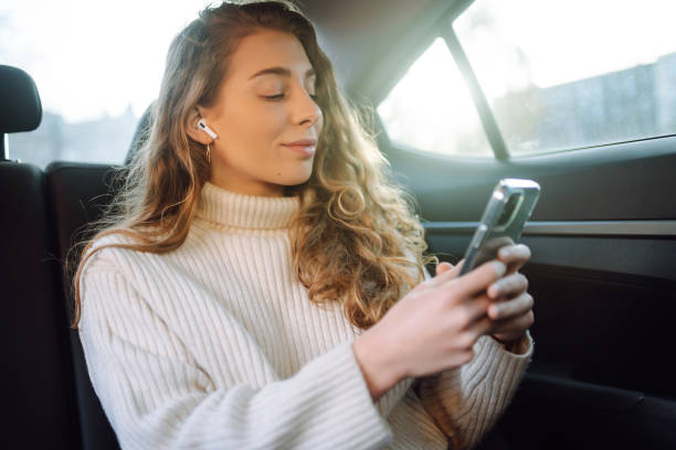 istock Young Woman using her phone during Traveling in a Car. 1456187497