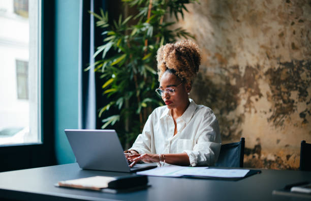 istock Businesswoman Using A Laptop Computer In The Cafe 1456192660