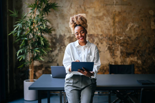 istock Smiling Businesswoman Using A Digital Tablet In The Cafe 1456192960