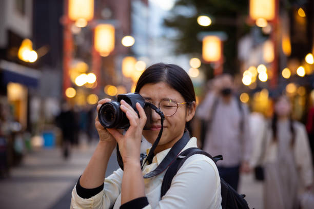 Female tourist taking photos at sunset time