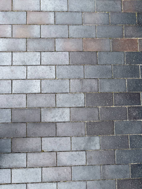 Grey rectangular paving stones - stock photo Pavement on footpath, pavement textures- stock photo pavement ends sign stock pictures, royalty-free photos & images