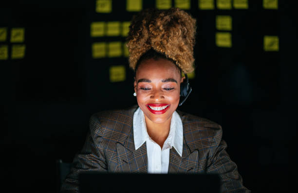 istock Smiling Businesswoman Talking With Customer While Using A Laptop Computer In The Office 1456193541