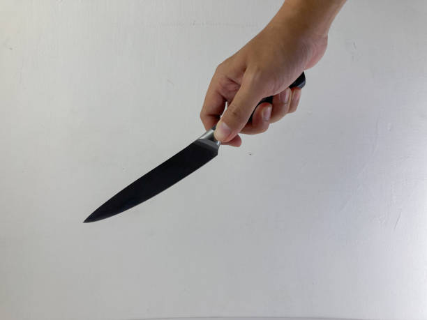 istock a male holding knife 1456196422
