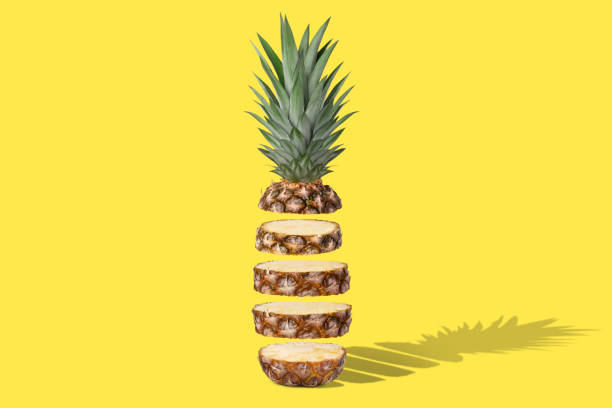 istock Fresh juicy pineapple in flight cut into rings. On a yellow background. 1456196478