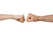 Man's and woman's fists near each other, about to fist bump. Fight, clash, conflict concept.
