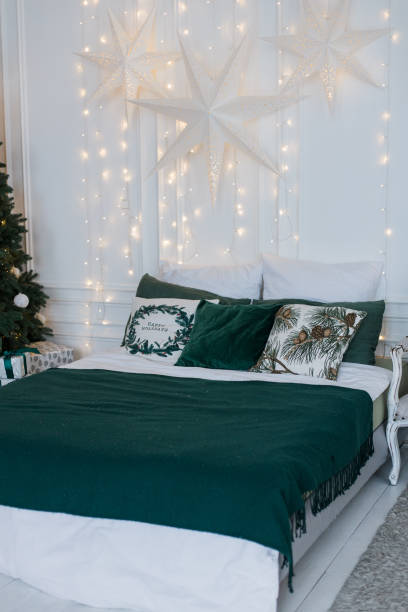 istock a large bed in a room with a garland on the wall 1456198344