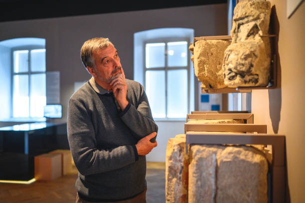 istock Grey-haired Man Admiring Ancient Tombstones 1456201539
