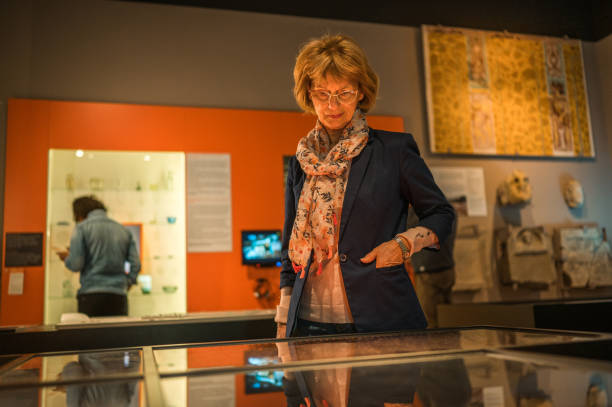 istock Senior Female Museum Visitor With Glasses 1456201554