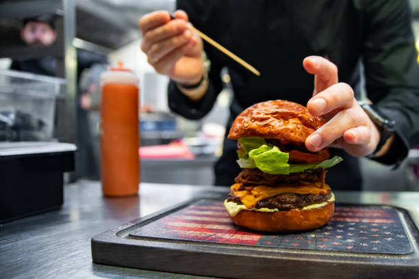 istock chef hand preparing a gourmet burger on restaurant kitchen step by step 1456201588