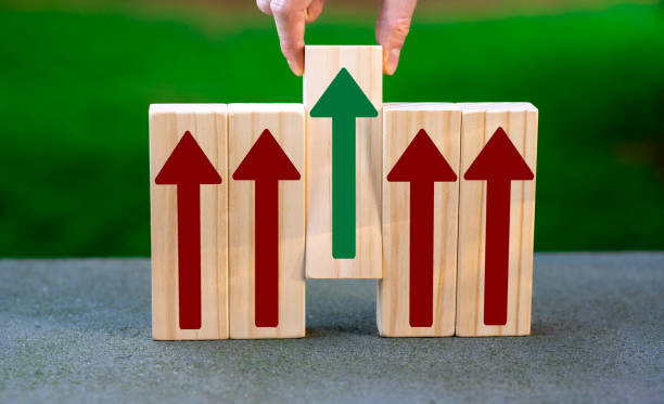 istock Wooden blocks with arrows pointing upwards. Hand selecting one block. Symbol for making the right decision. 1456203790