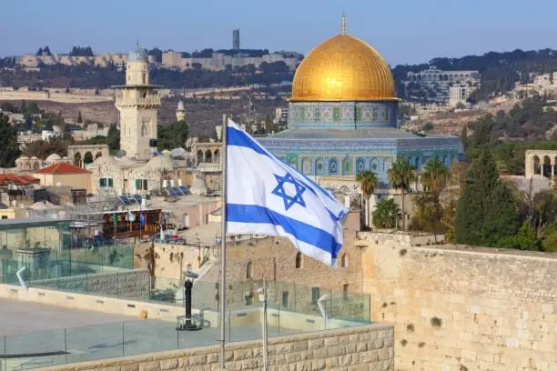 Jerusalem Old City with Dome of the Rock and flag of Israel.