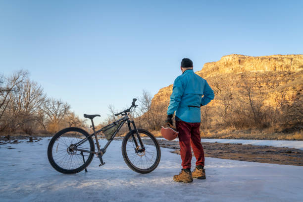 istock male cyclist contemplating winter sunset 1456205736