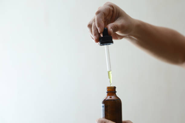 istock hand takes the serum from the bottle using a glass pipette 1456207239
