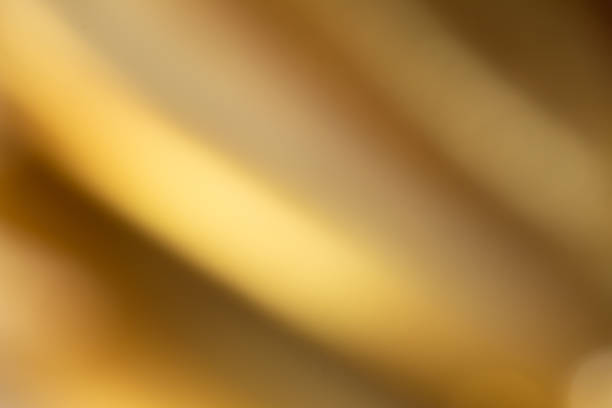 istock A golden background image with diagonal gradients. Gives a feeling of light, looks dimensional and luxurious. 1456207827