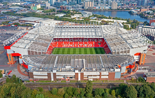 3D soccer stadium with green grass and bleachers full of people. Grass, lights stadium, and all other elements are made in 3D.