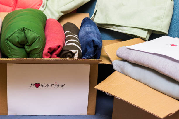 istock Clothes Donation. Box of warm cloth with donate label 1456211455