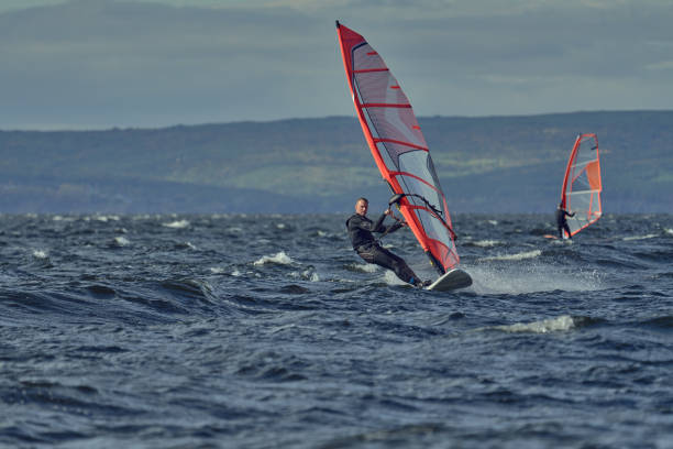 istock Windsurfers move on the surface of the water 1456211880