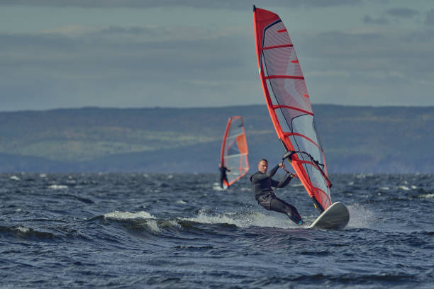 istock Windsurfers move on the surface of the water 1456211882