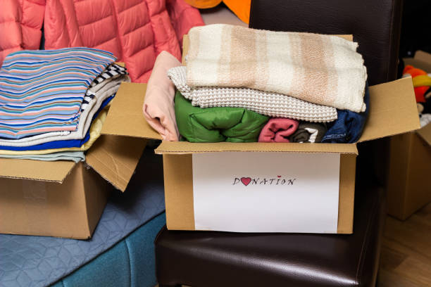 istock Clothes Donation. Box of warm cloth with donate label 1456211885