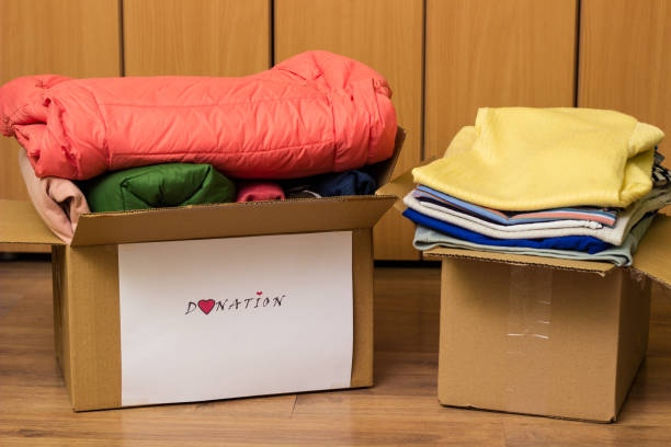 istock Clothes Donation. Box of warm cloth with donate label 1456211918