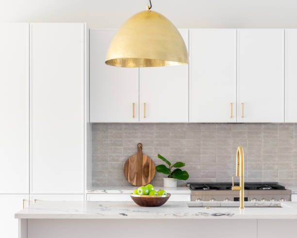 istock A white kitchen detail with gold light and faucet. 1456214147