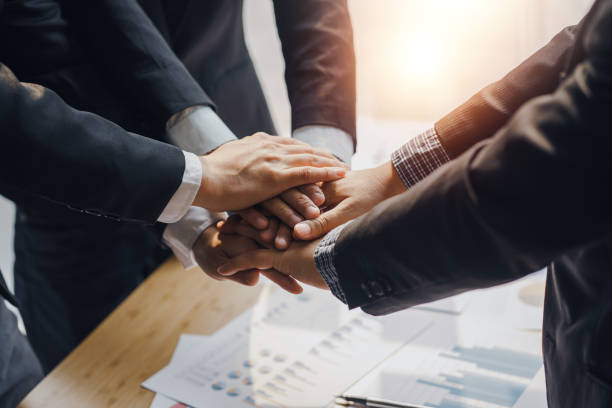 istock Business people putting their hands together. Stack of hands and together working on new startup project. Unity and teamwork concept. 1456214868