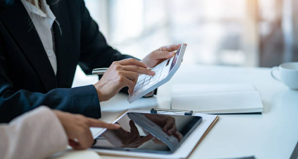 istock Business people discuss investment project working and planning strategy and using calculator during a business meeting. 1456215071