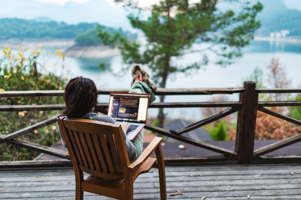 istock Woman working remote from country house terrace 1456215320
