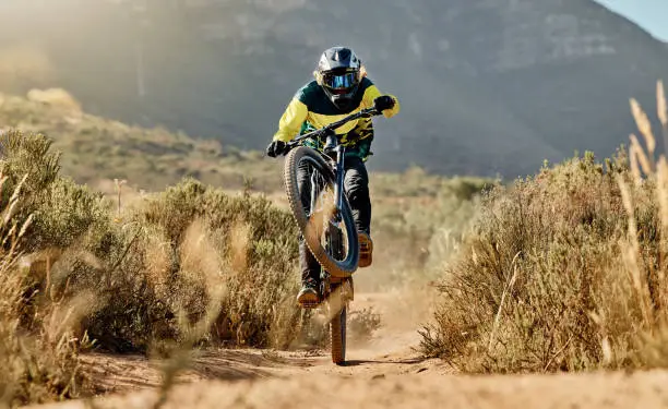 Mountain biker, dirt bike and dessert rider cycling on bmx bicycle on nature path, dirt road and extreme sports performance. Adventure race competition, outdoor racer and pro cycling in Vegas Nevada