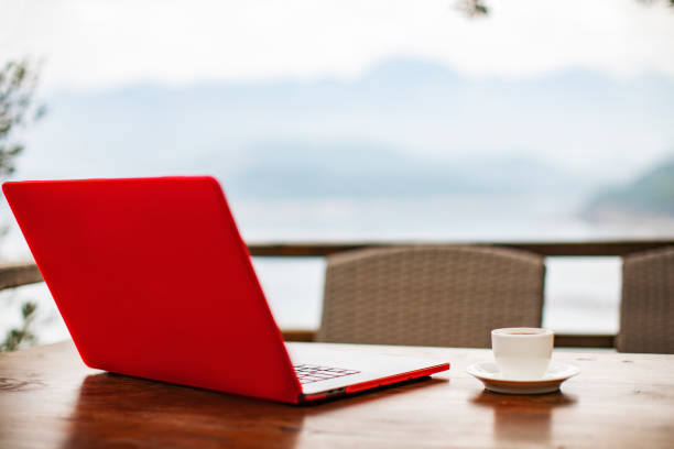 istock Laptop on the table outdoors with a cup of coffee, working from home 1456216745
