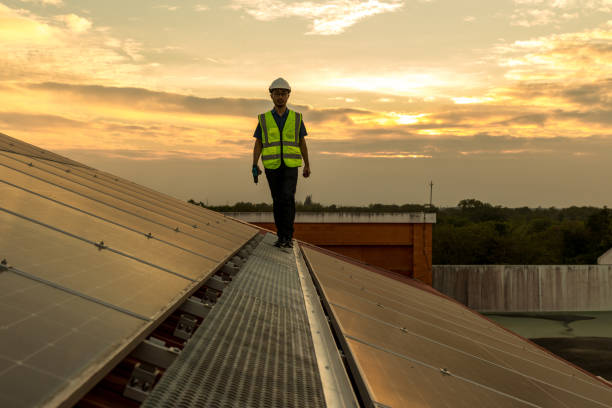 istock Engineer working setup Solar panel at the roof top. Engineer or worker work on solar panels or solar cells on the roof of business building 1456218528