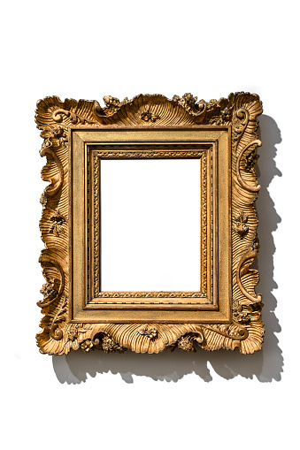Golden vintage frame isolated on white wall in museum.
