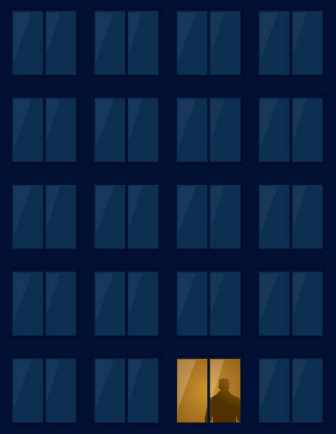 istock Man alone in the illuminated window of a building 1456218777