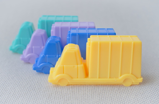 Concept image series of plastic toy cars and trucks in pastel colors illustrating situations. These photographs can be useful as dividers, illustrations, the introduction of an idea, a demonstration or a presentation.