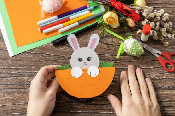istock A child is holding an Easter card gift Easter bunny. Handmade. Project of children's creativity, handicrafts, crafts for kids. 1456220297