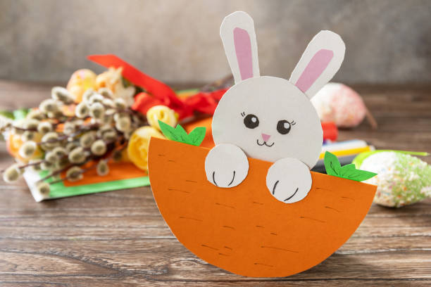 istock Easter card gift Easter bunny on a wooden table. Handmade. Project of children's creativity, handicrafts, crafts for kids. 1456220307