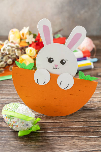 istock Easter card gift Easter bunny on a wooden table. Handmade. Project of children's creativity, handicrafts, crafts for kids. 1456220344